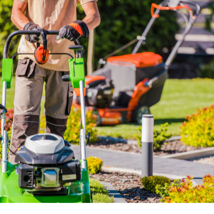 Landscaping RentalsA landscaper outdoors pushing a lawn mower with power equipment behind them