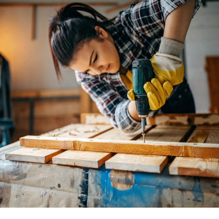 Do-It-Yourself RentalsWoman using a power drill indoors on wood project