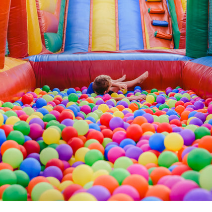 Party & Event RentalsA bounce house with a ball pit with a kid playing in it